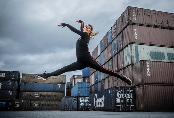 Image of woman in motion suit jumping