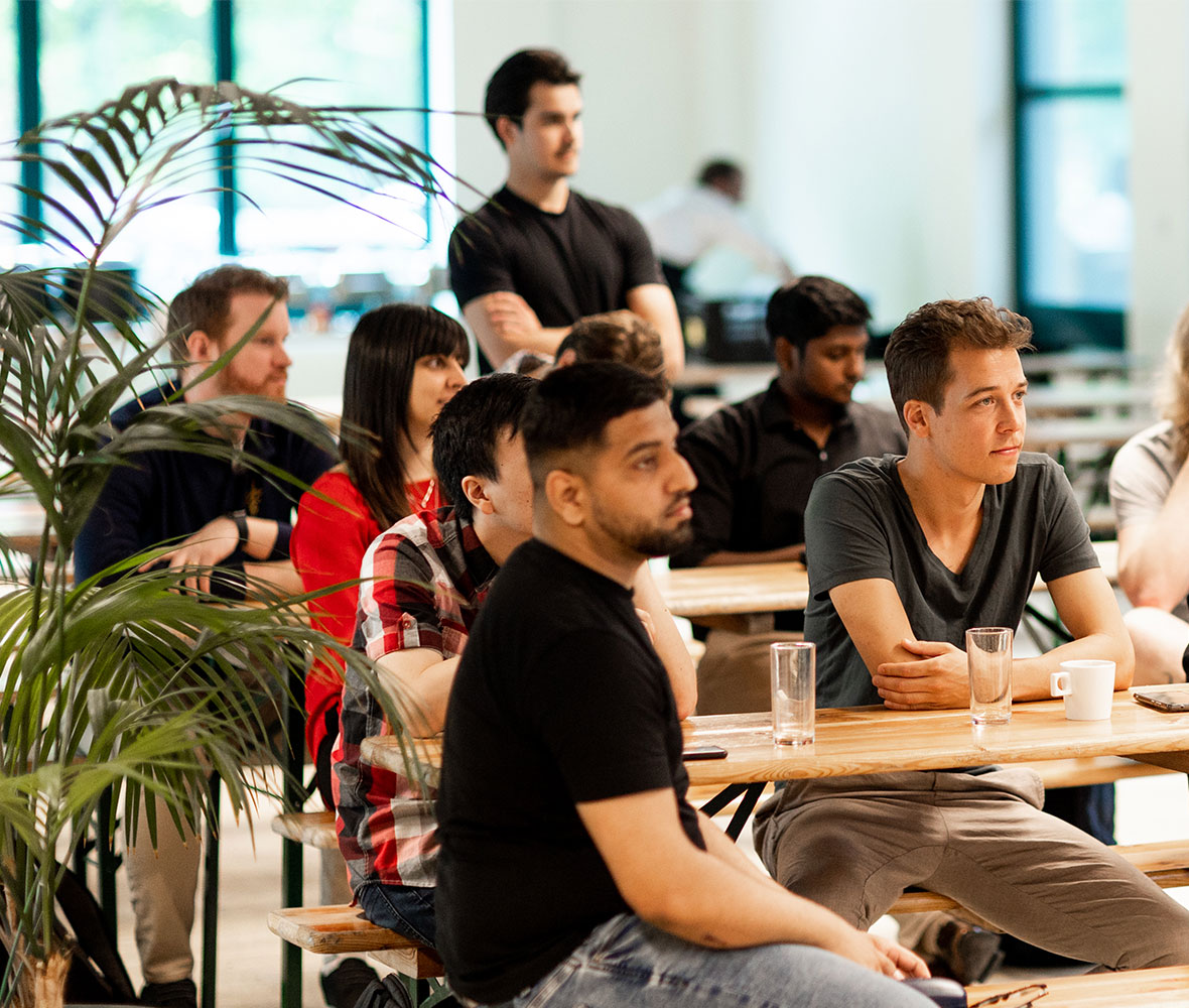 Image of a roomful of people sat at desks