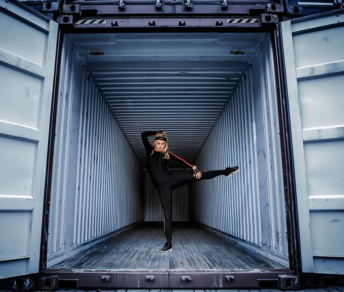 Image of woman dancing inside a container
